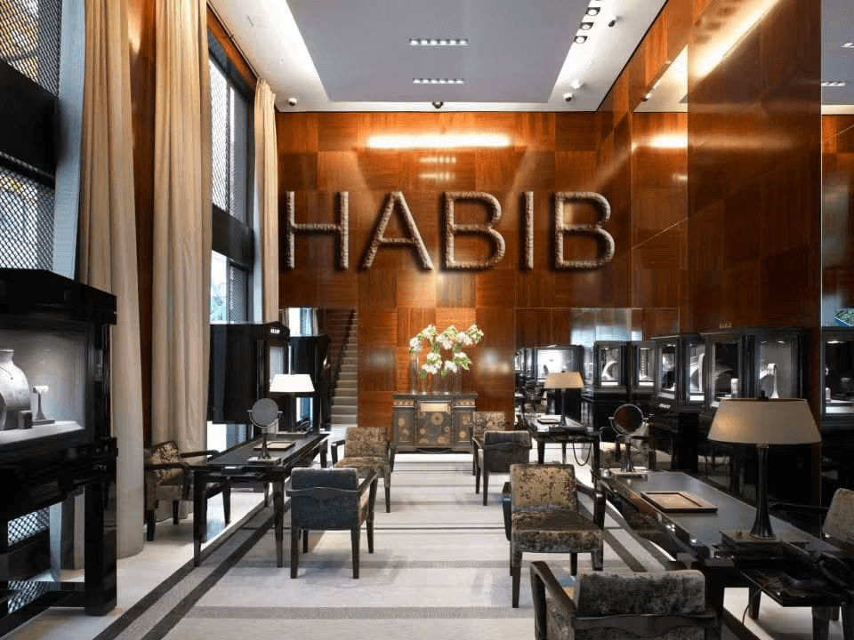 The Habib Abou Jaoude boutique in Jal el Dib, a wood-panelled showroom with lit display cases